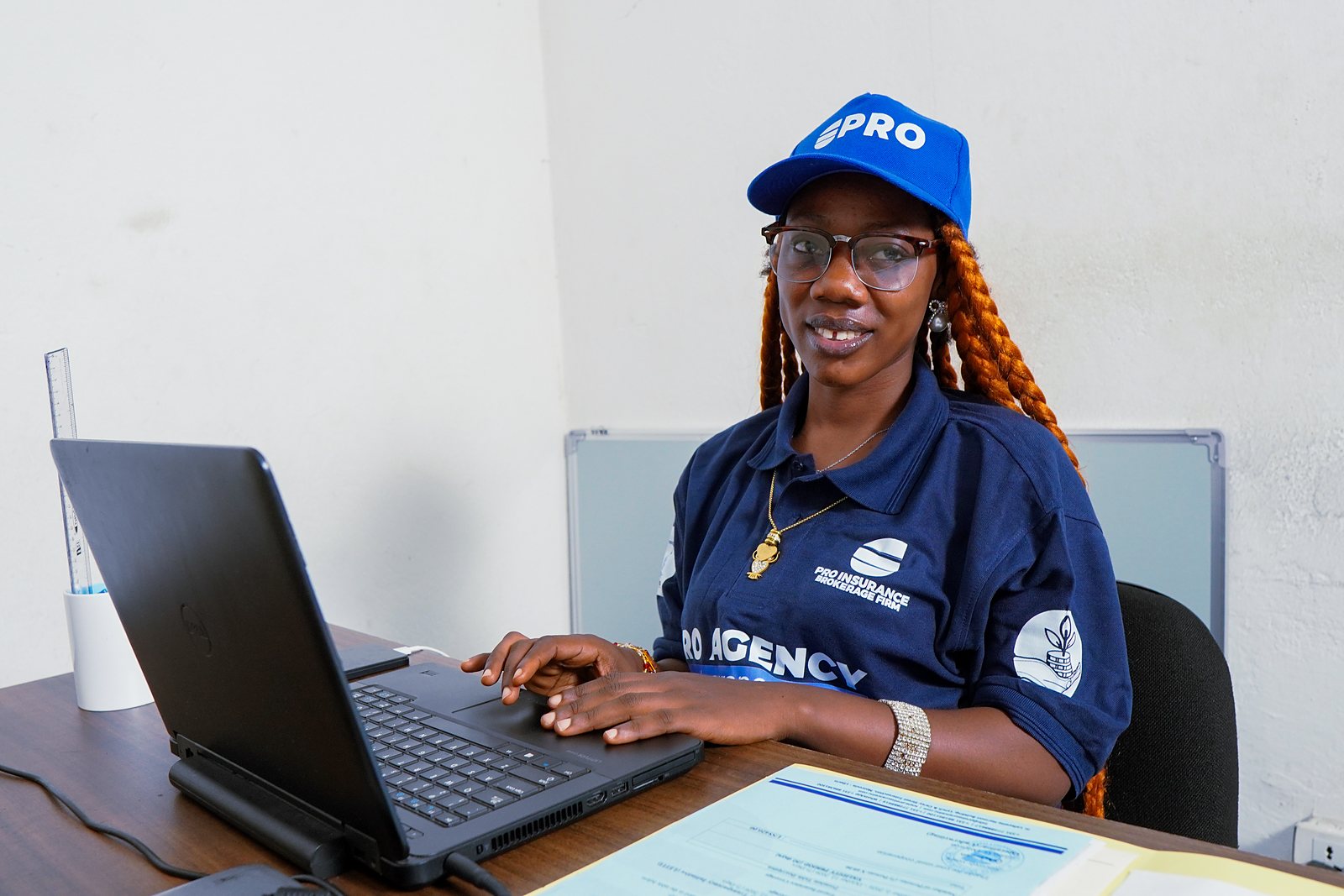 A Pro-Insurance adviser preparing client policy documents at her desk